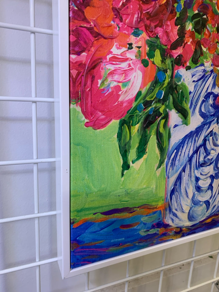 PINK FLOWERS IN BLUE VASE IN WHITE FRAME WALL HANGING.