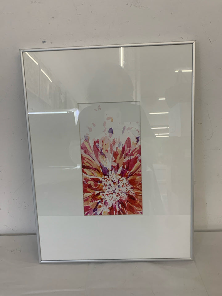 COLORED STARBURST IN WHITE FRAME SILVER TRIM WALL ART.