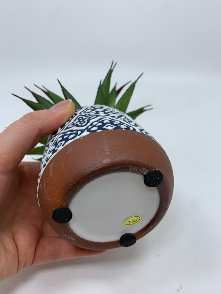 FAUX SUCCULENT IN BLUE AND WHITE CERAMIC POT.