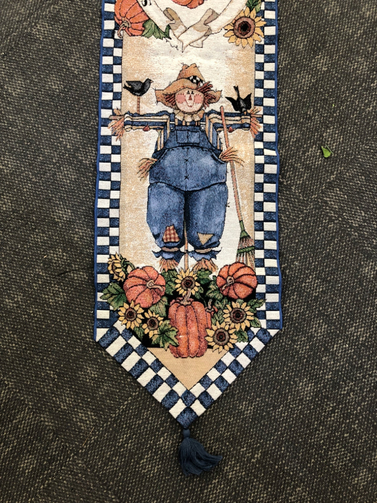 SCARECROW/PUMPKIN TABLE RUNNER W BLUE CHECKERED EDGES.