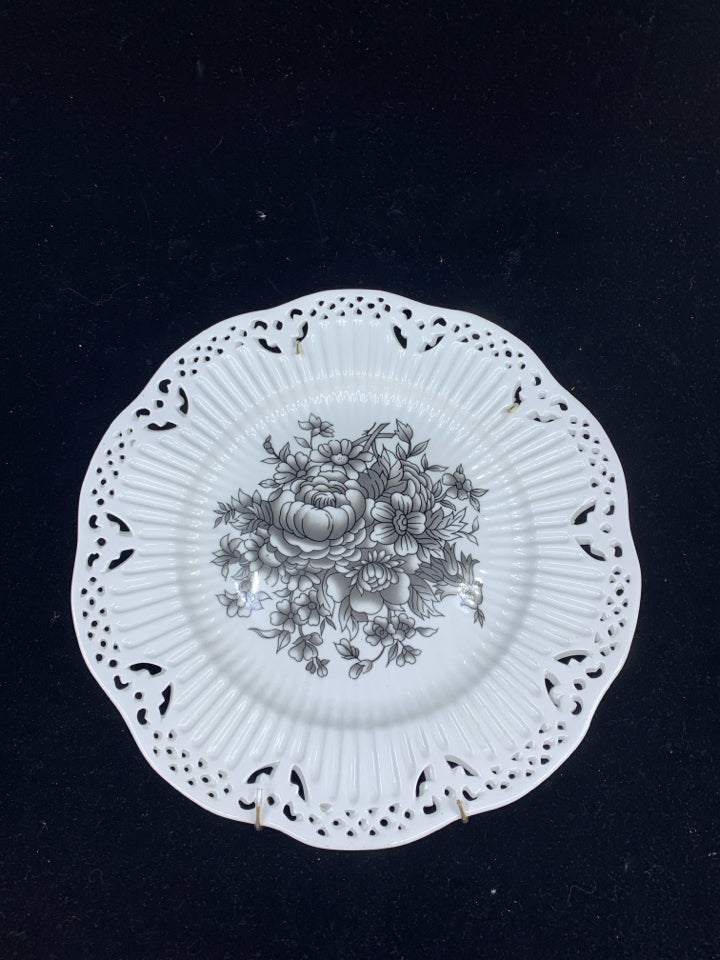 WHITE DECORATIVE PLATE W/BLACK FLOWERS.