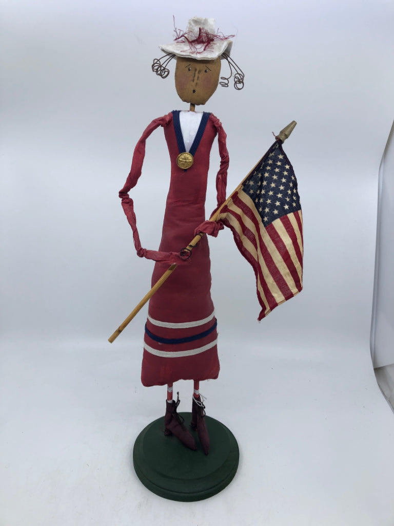 PRIMITIVE WOMAN HOLDING FLAG.
