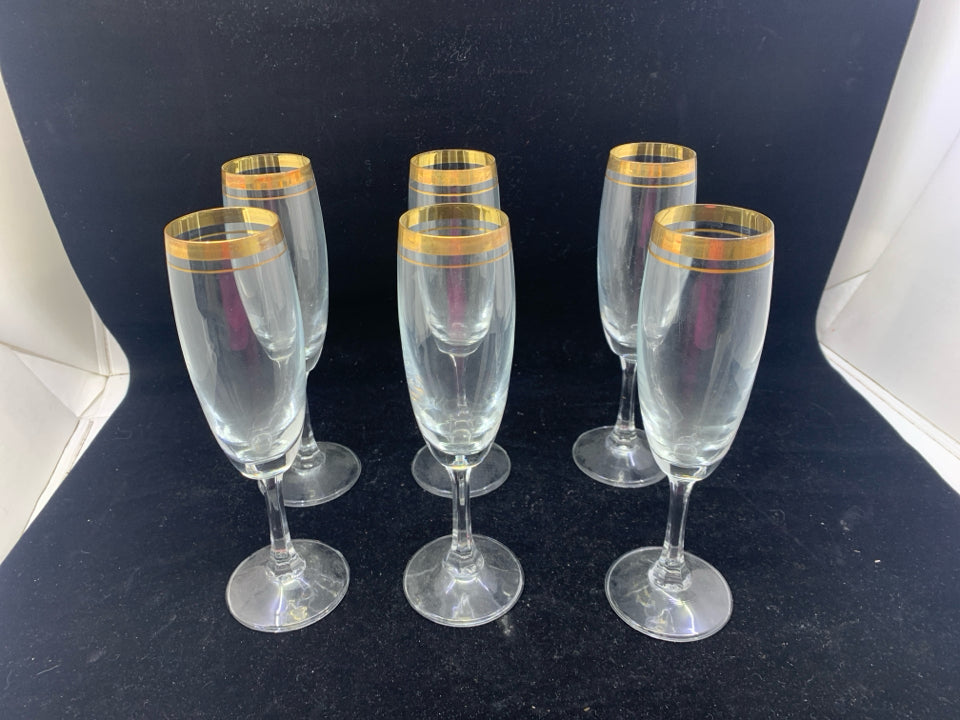 6 GOLD RIMMED CHAMPAGNE FLUTES.