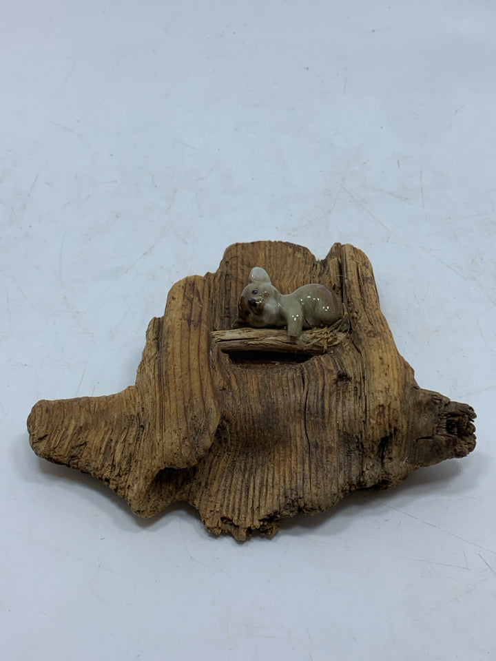 PORCELAIN KOALA ON RECLAIMED WOOD PIECE.