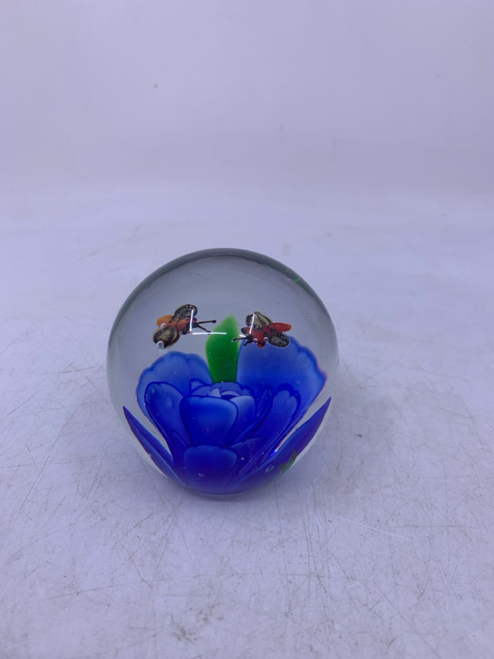 BLOWN GLASS SPHERE W/ BLUE FLOWER BEES FLYING ABOVE IT.