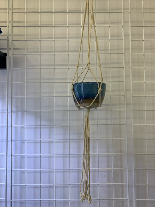BLUE POTTERY WITH MACRAME HANGER.