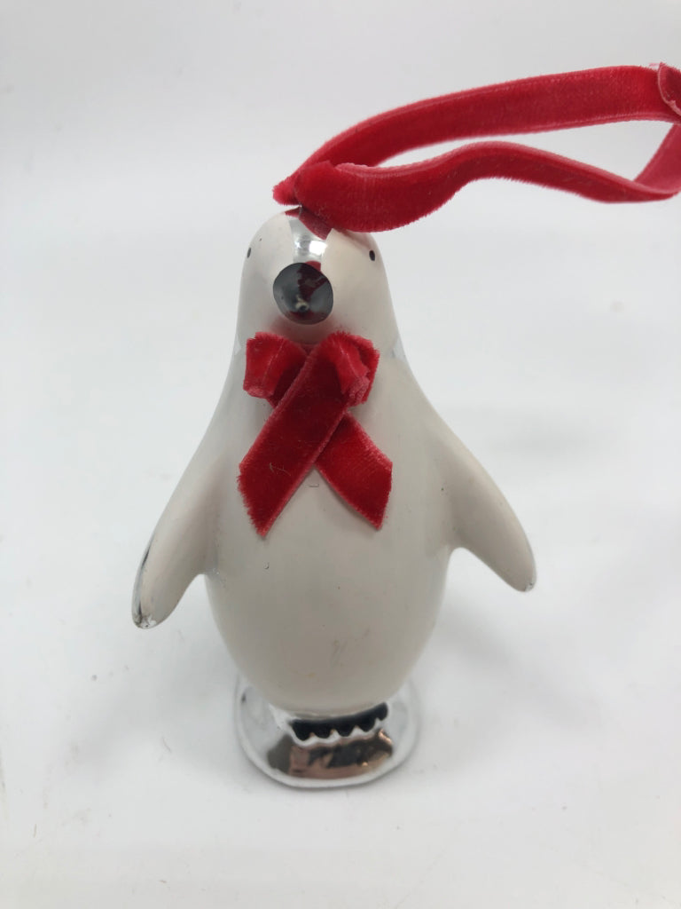 SILVER PENGUIN W/RED BOW ORNAMENT.