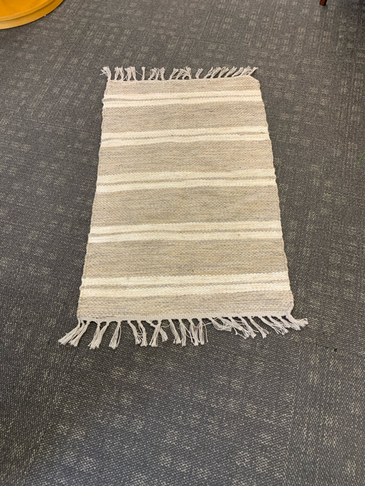 CREAM STRIPE AREA RUG W FRINGE.