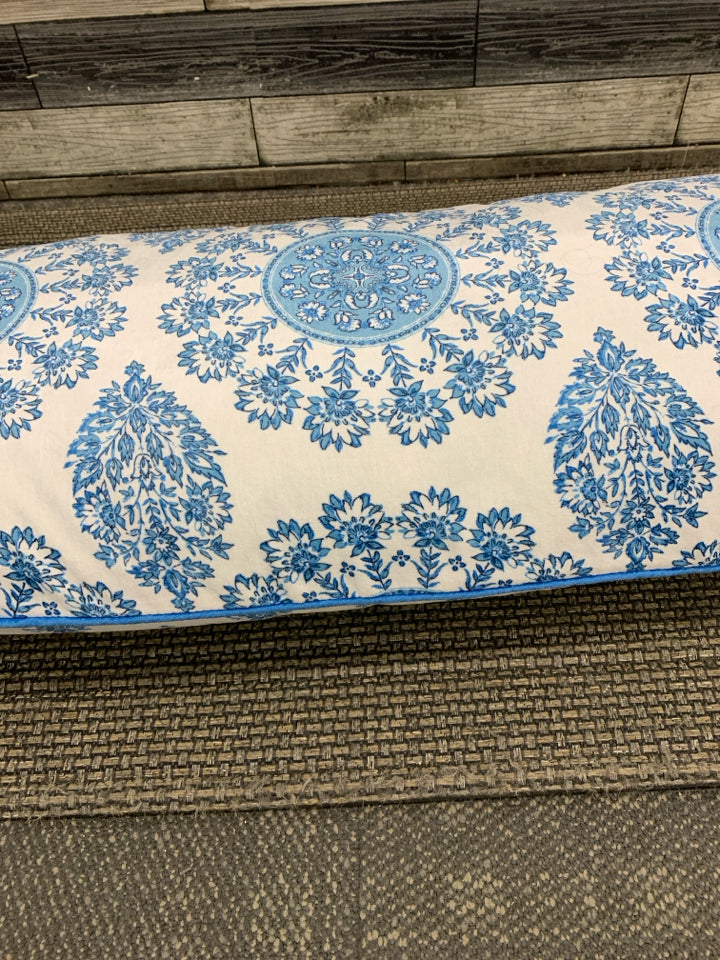 LONG BLUE FLORAL PILLOW W/YELLOW ACCENTS.