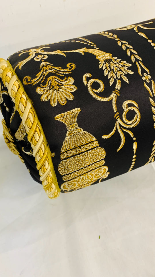 BLACK AND GOLD CYLINDER PILLOW.