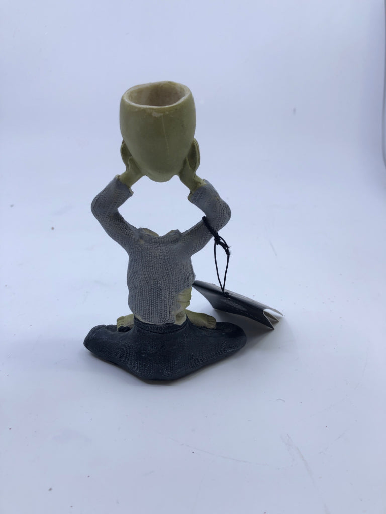ZOMBIE HOLDING HEAD TAPER CANDLE HOLDER.