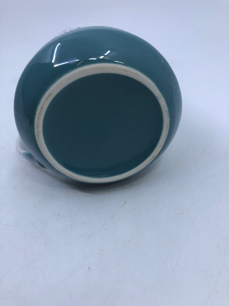 LOVE NEVER FAILS WHITE AND TEAL MUG.