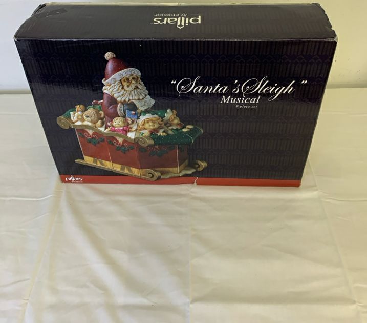 ENESCO PILLARS SANTA SLEIGH MUSICAL 9 PC SET.