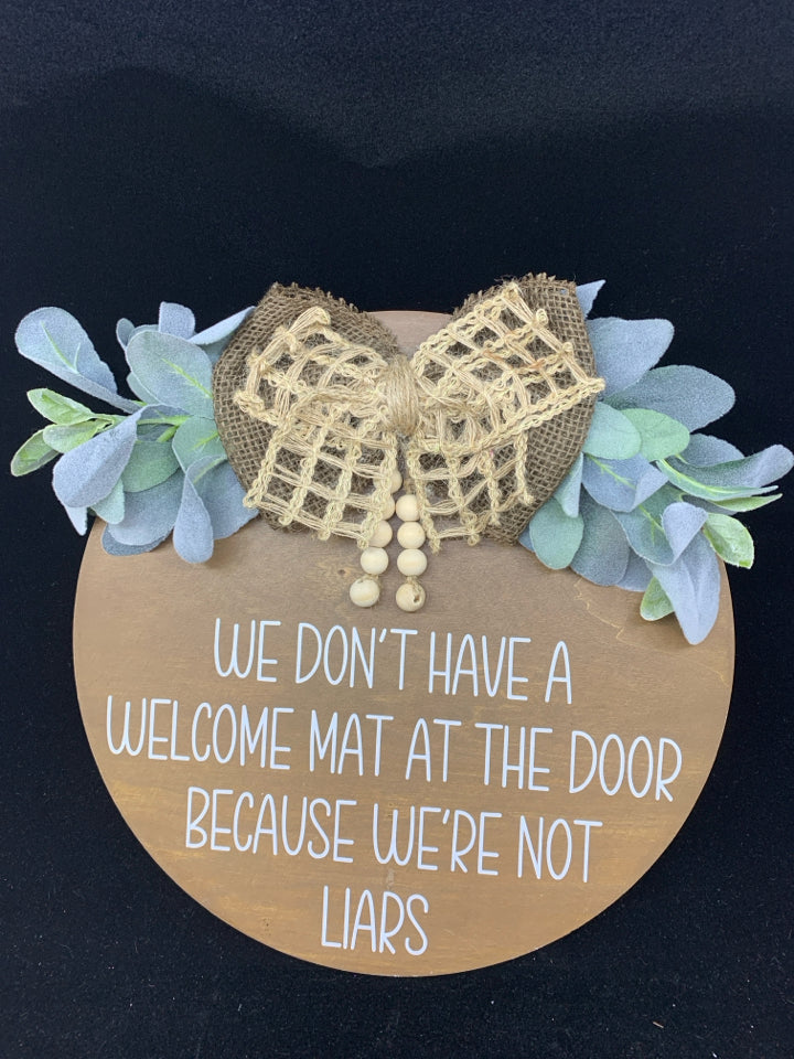 ROUND "WE DON'T HAVE A WELCOME MAT" DOOR HANGING.