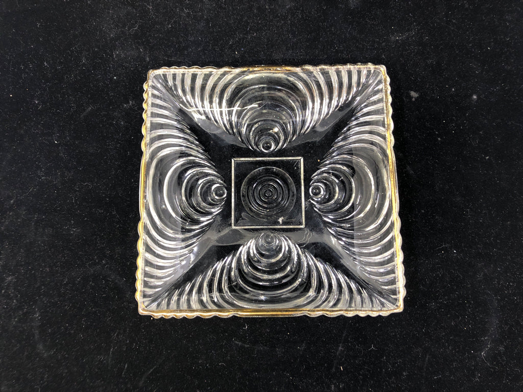 SMALL SQUARE BOWL W CIRCLE PATTERN AND GOLD RIM.