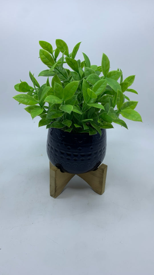 FAUX GREENERY IN BLUE RAISED PLANTER.