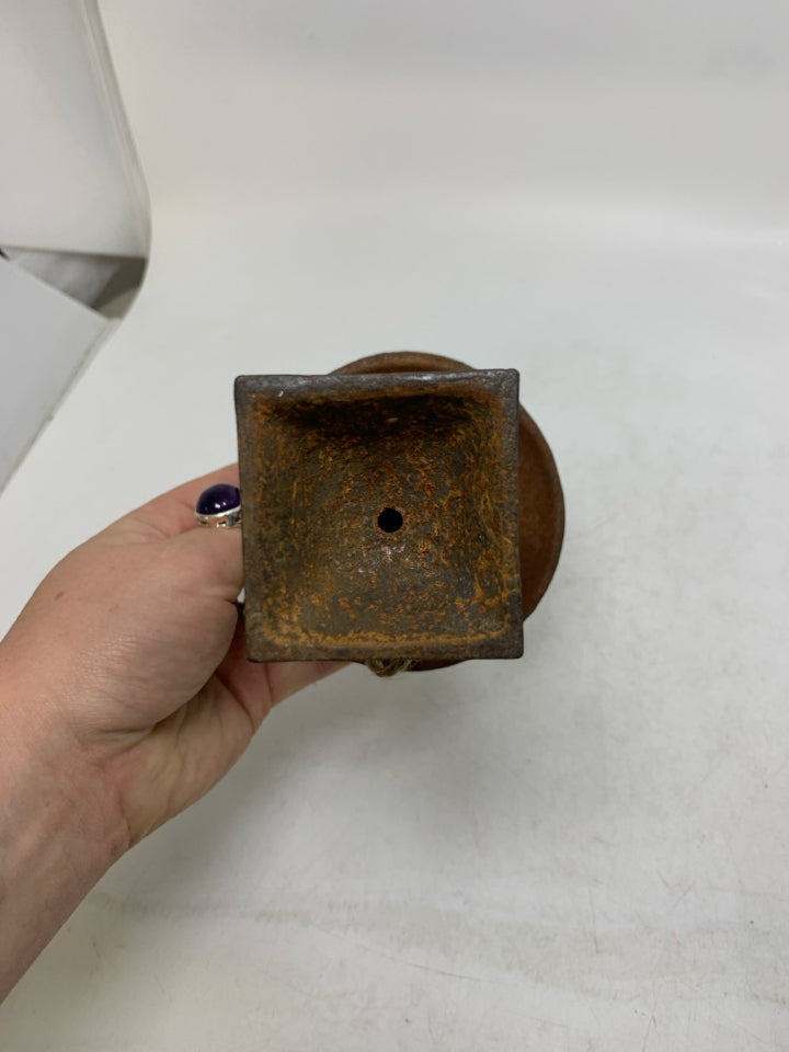RUSTED HEAVY METAL FOOTED VASE.