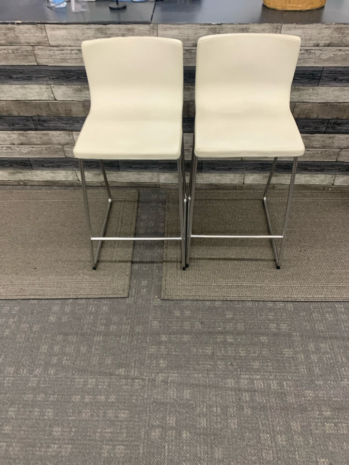 2 WHITE FAUX LEATHER STOOLS.