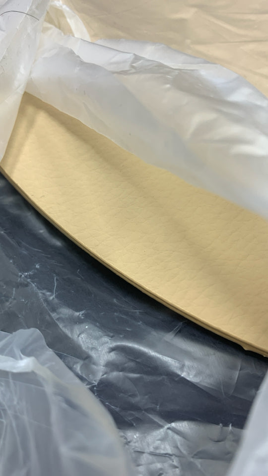 NIP 6PC CREAM COLORED LEATHER-BACKED PLACEMATS.