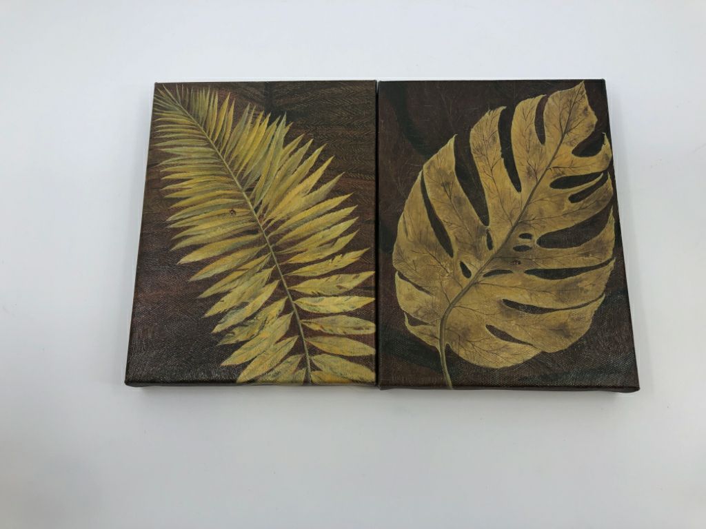 2 SMALL CANVASES W/ FERN LEAF+MONSTERA LEAF BROWN BACKGROUND.