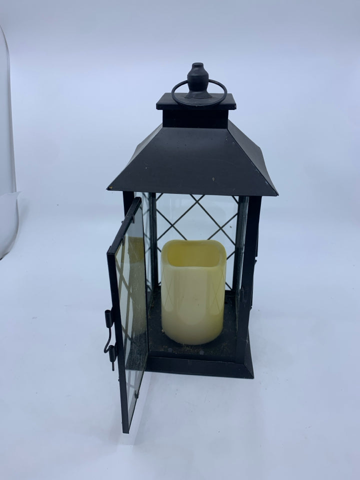 FLAMELESS CANDLE IN METAL LANTERN.