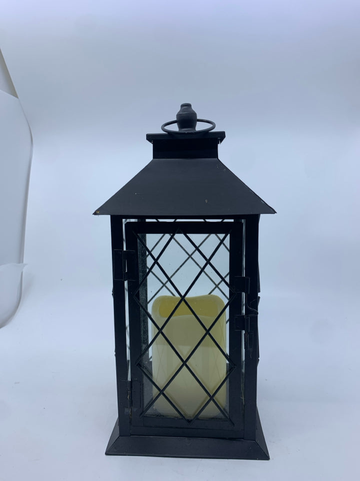 FLAMELESS CANDLE IN METAL LANTERN.