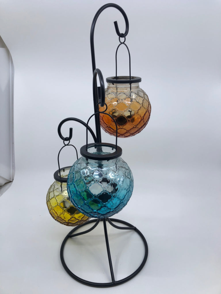 3 COLORED EMBOSSED GLASS TEA LIGHT HOLDER HANGING ON BLACK STAND.
