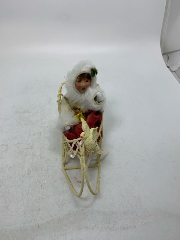 VTG BYER'S CHOICE GIRL IN SLED HOLDING PRESENT CAROLER.