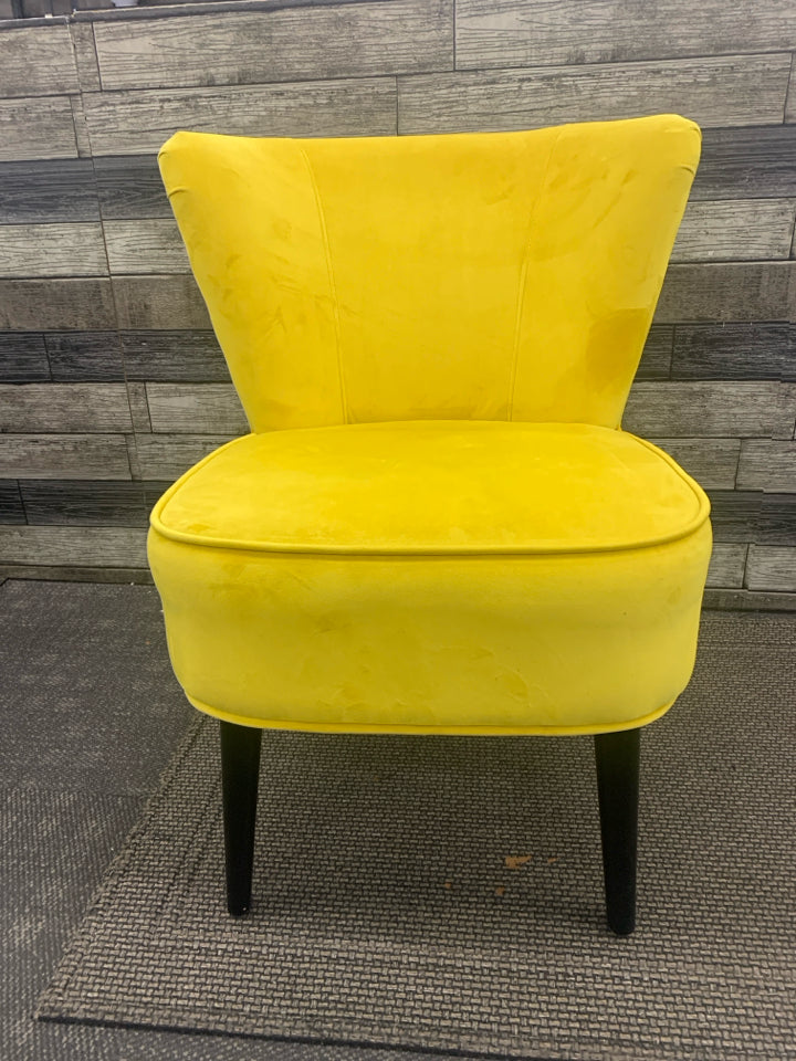 BRIGHT YELLOW VELVET LOW ACCENT CHAIR W/ BLACK LEGS.