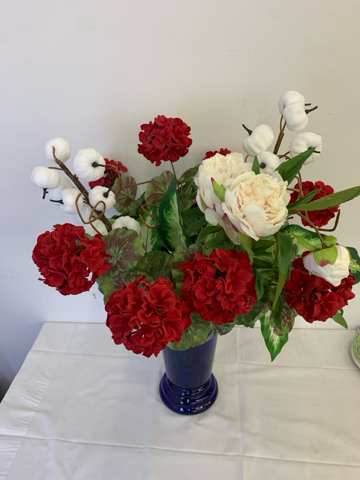 TALL BLUE VASE W PUMPKIN AND FAUX RED AND WHITE FLORAL.