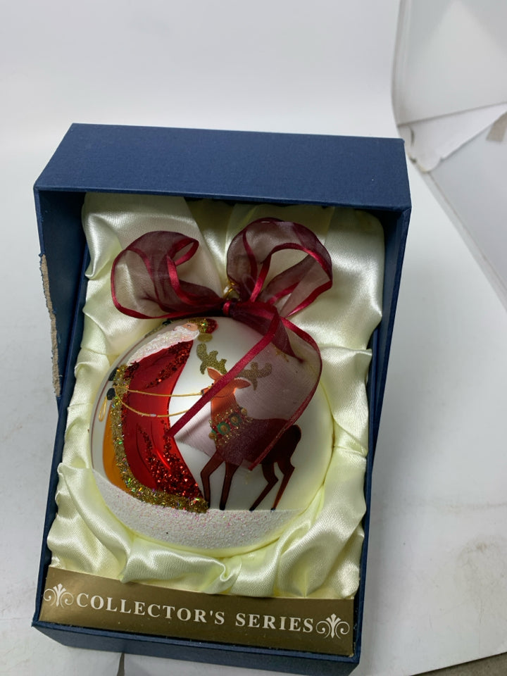 LARGE WHITE ORNAMENT W/ SANTA WALKING REINDEER IN BOX.