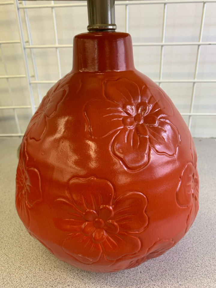 RED CERAMIC BASE W/ EMBOSSED FLOWERS TEXTURED SHADE.