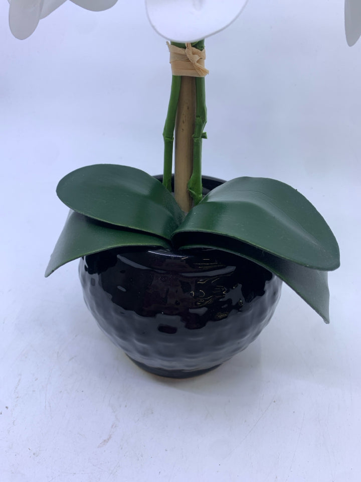 FAUX WHITE ORCHID FLORAL IN BLACK PLANTER.