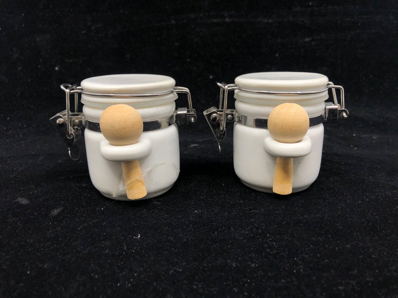 2 SMALL WHITE CANISTERS W WOOD SPOONS.