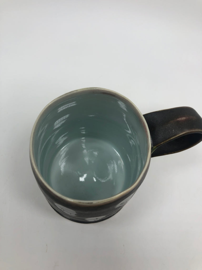 MATTE BLACK DOTTED POTTERY MUG W/INNER BLUE GLAZE.