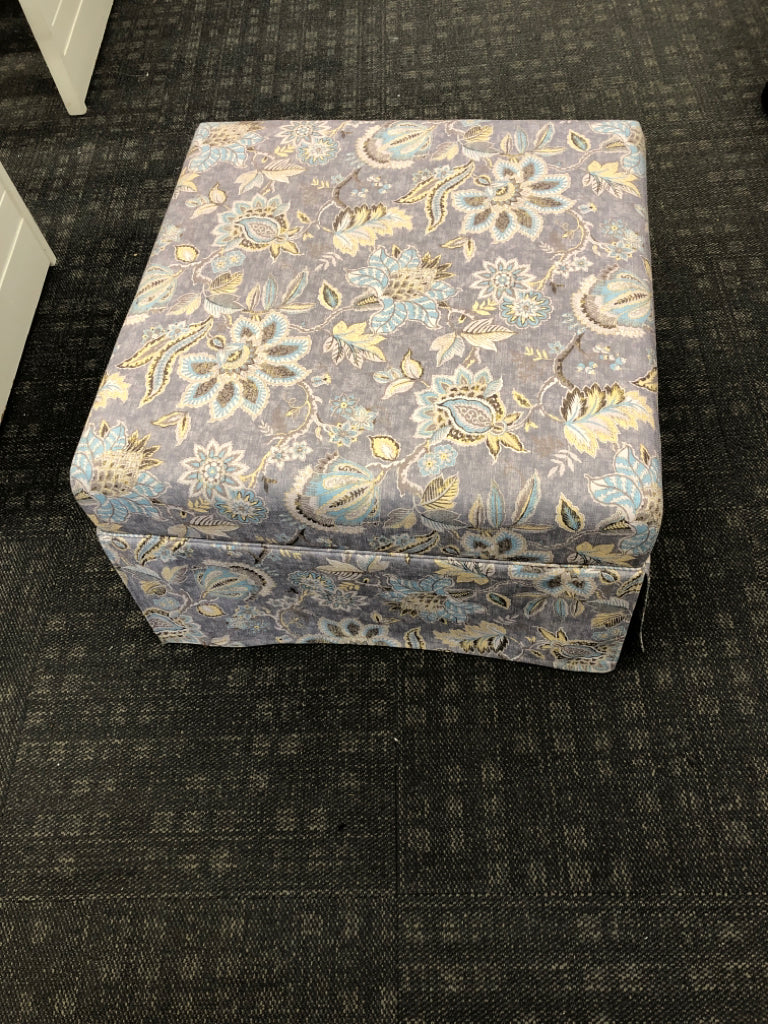GREY FLORAL UPHOLSTERED OTTOMAN.
