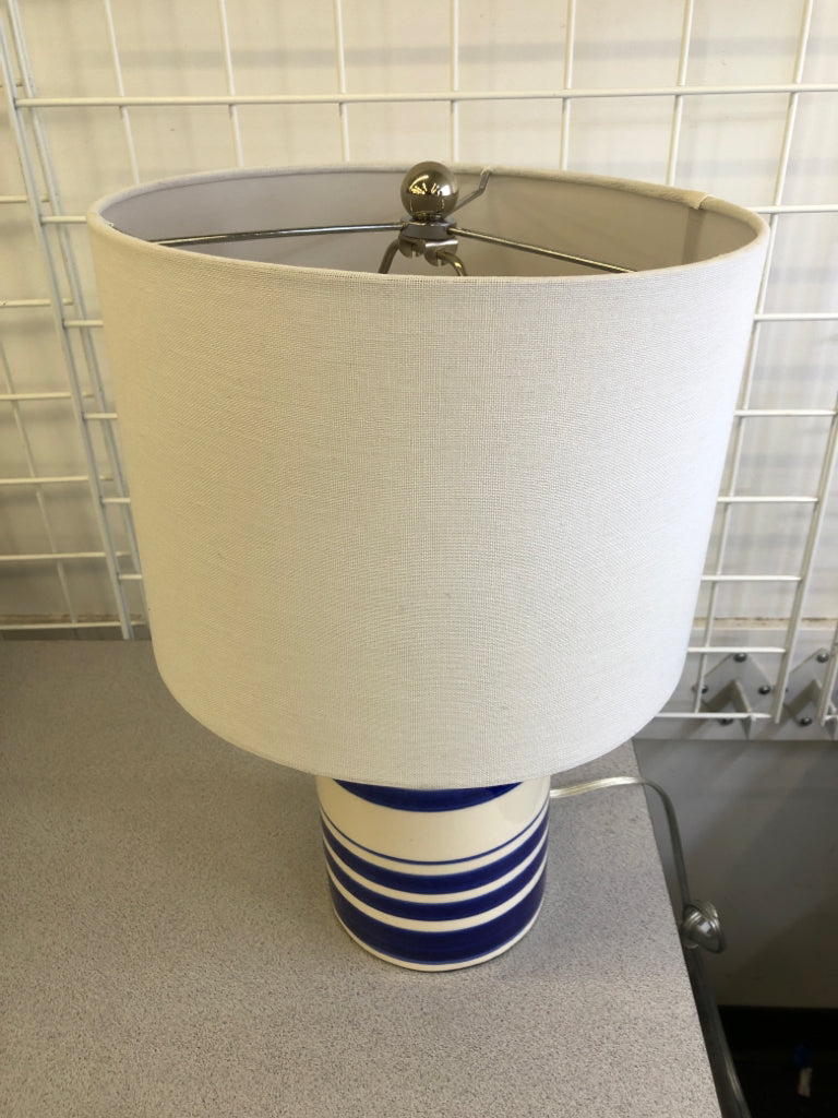 BLUE WHITE STRIPE CERAMIC LAMP W/WHITE SHADE.
