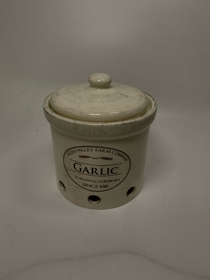 CERAMIC GARLIC HOLDER CANISTER W/ HOLES IN BOTTOM.