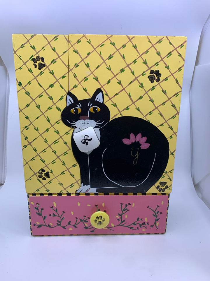 BLACK/WHITE PAINTED CAT W/ YELLOW BACKGROUND W/DRAWER WALL HANGING.