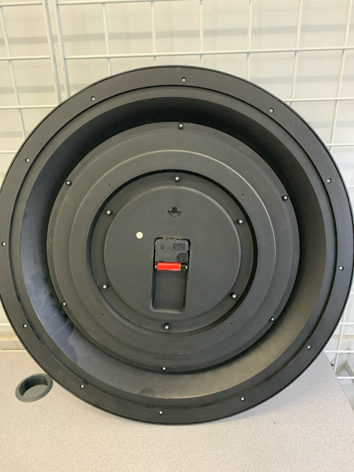 BLACK CLOCK W/BRASS PAINTED NUMBERS.