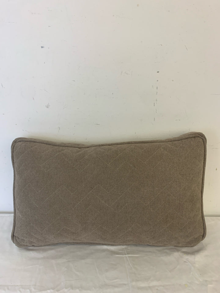 RECTANGLE DARK TAN PILLOW W/ ZIG ZAG STITCHING.