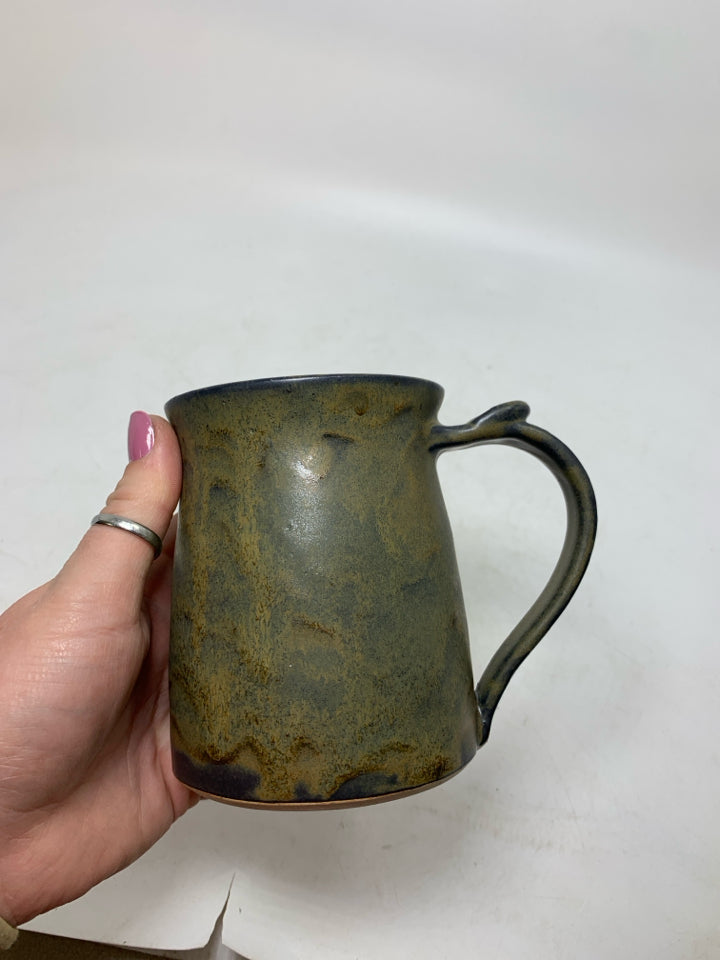DARK COLORED POTTERY MUG.