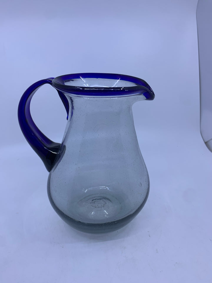 CLEAR GLASS PICTURE W/BLUE HANDLE AND RIM.