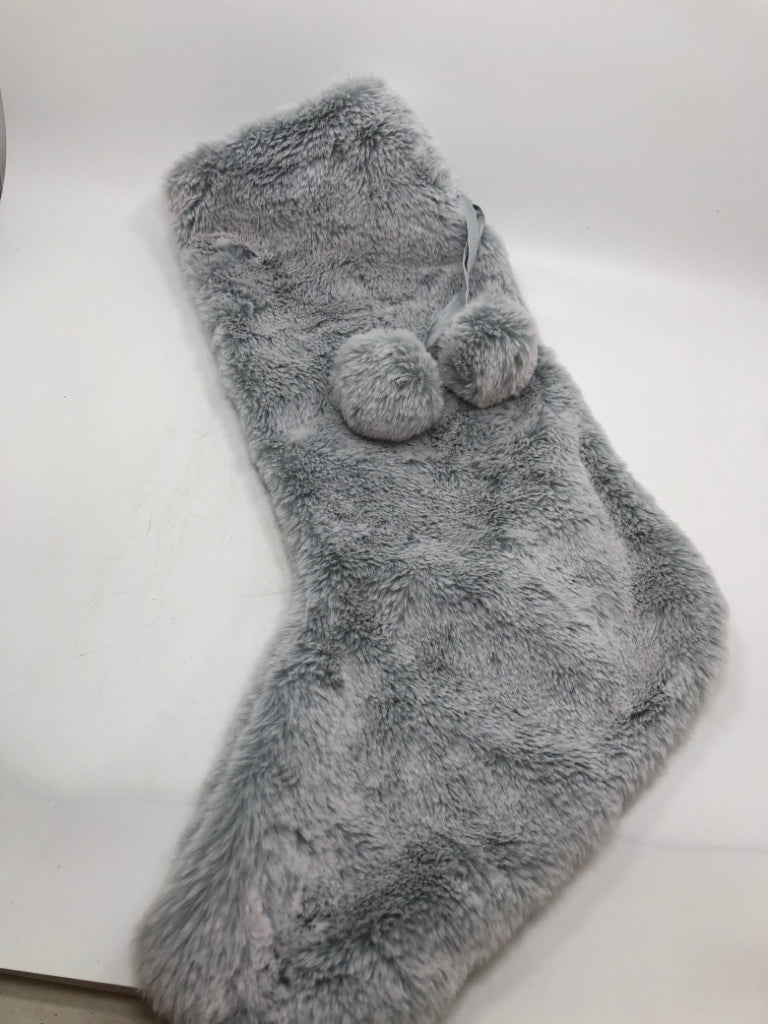 GRAY FLUFFY STOCKING W/ POM POMS.