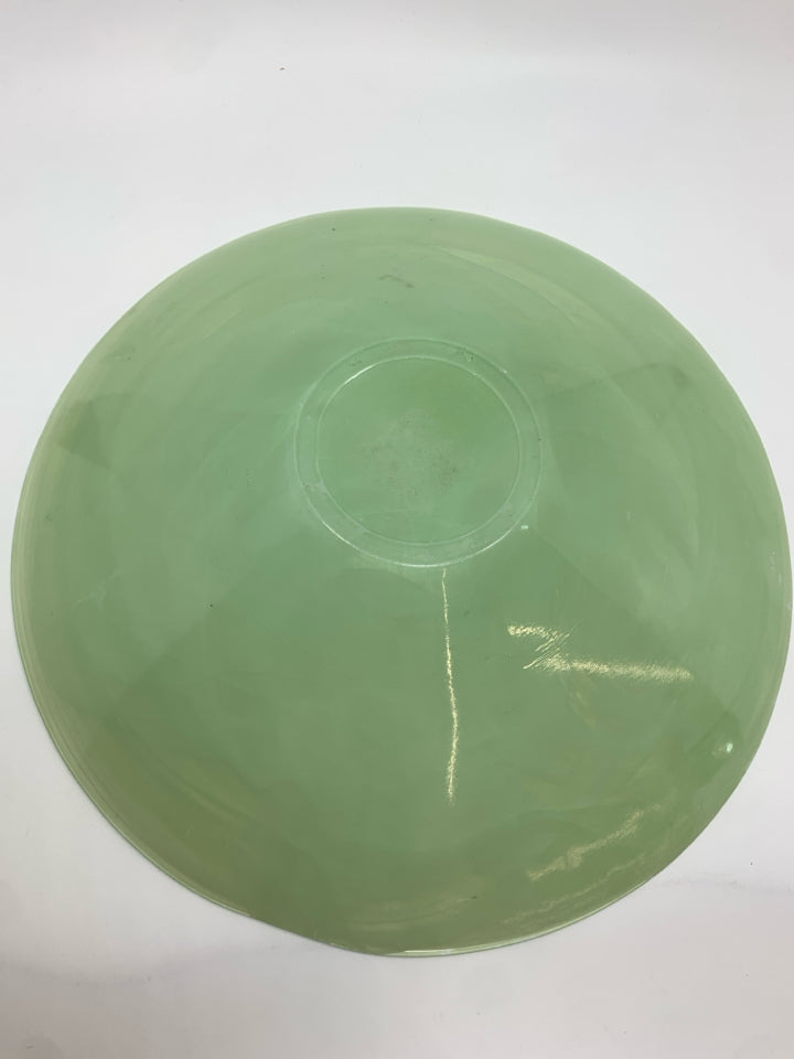WHITE SWIRL IN GREEN GLASS BOWL.