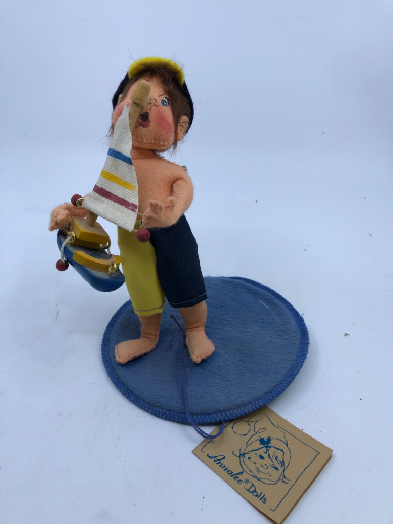 ANNA LEE LITTLE BOY HOLDING SAIL BOAT.