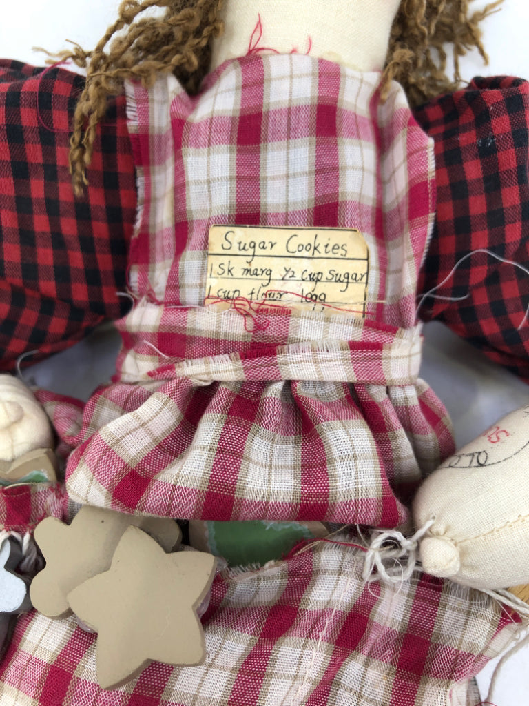 PRIMITIVE DOLL BAKING IN RED DRESS.