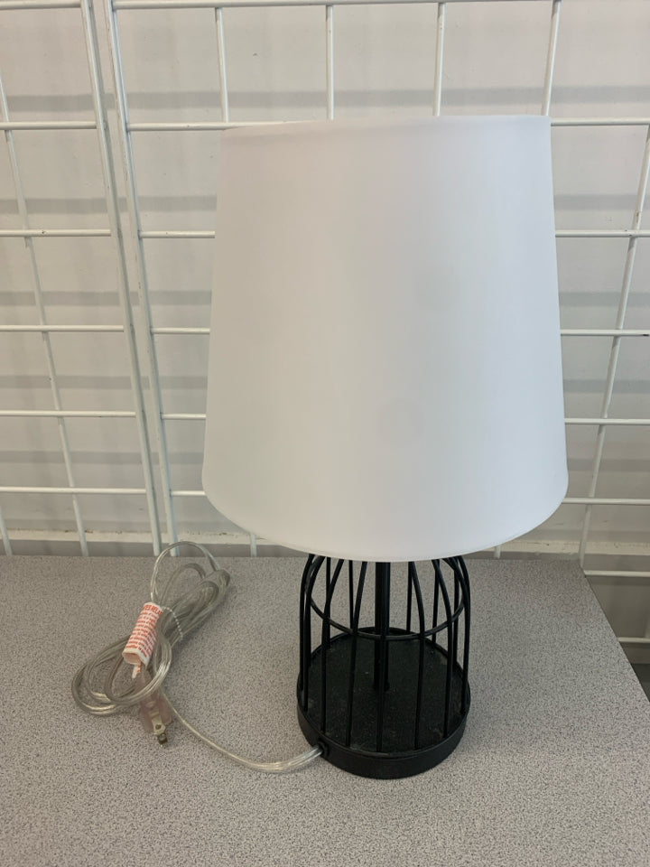 METAL CAGE LAMP WITH WHITE SHADE.