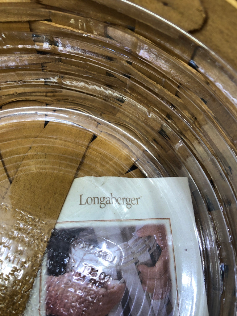 ROUND BASKET W PLASTIC LINER AND LEATHER HANDLES.