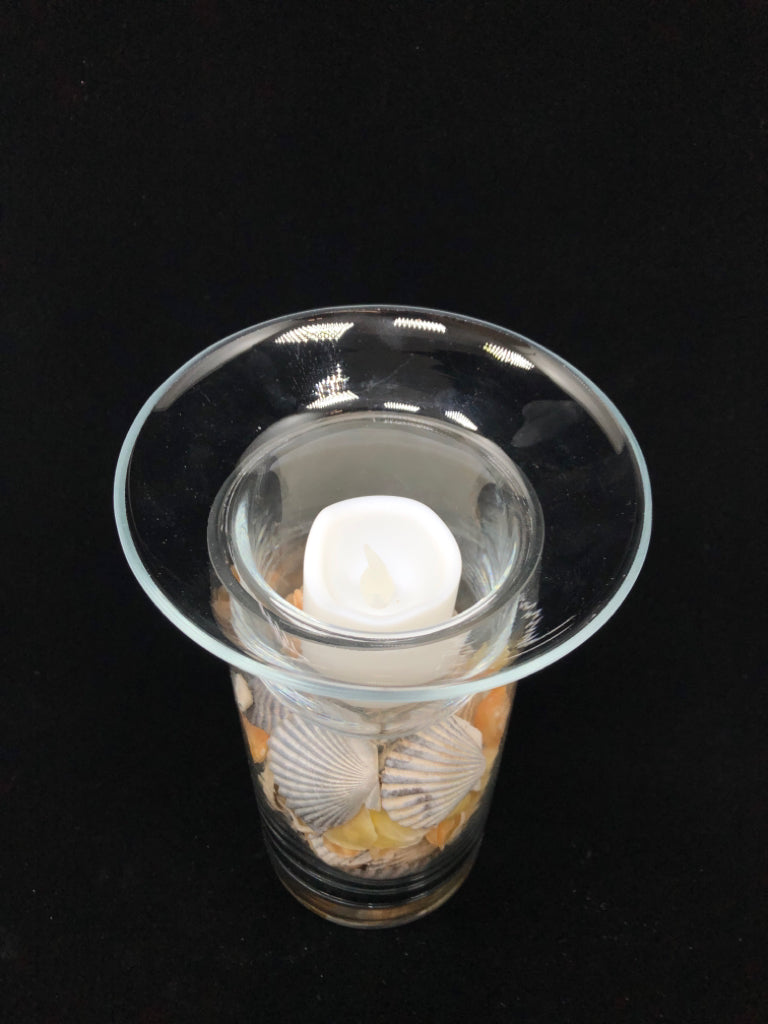 SEASHELL FILLED GLASS CANDLE HOLDER.